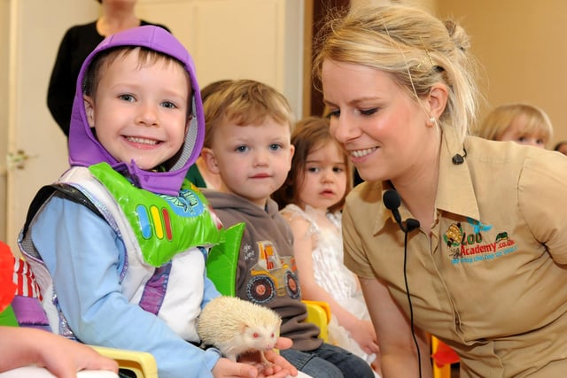 The children look so happy to see this visitor to their playgroup.