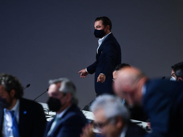 Di Caprio gestured as he arrived for a meeting, as part of the World Leaders' Summit of the COP26 UN Climate Change Conference.