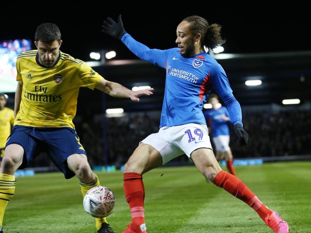 Portsmouth's Marcus Harness battles with Arsenal's Sokratis Papastathopoulos in the first half.