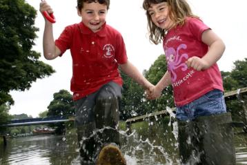 Oliver and Lucy Cawood having fun splashing in a puddle in 2007.