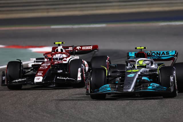ewis Hamilton of Great Britain driving the (44) Mercedes AMG Petronas F1 Team W13 leads Zhou Guanyu of China driving the (24) Alfa Romeo F1 C42 Ferrari during the F1 Grand Prix of Bahrain at Bahrain International Circuit on March 20, 2022 in Bahrain, Bahrain. (Photo by Lars Baron/Getty Images)