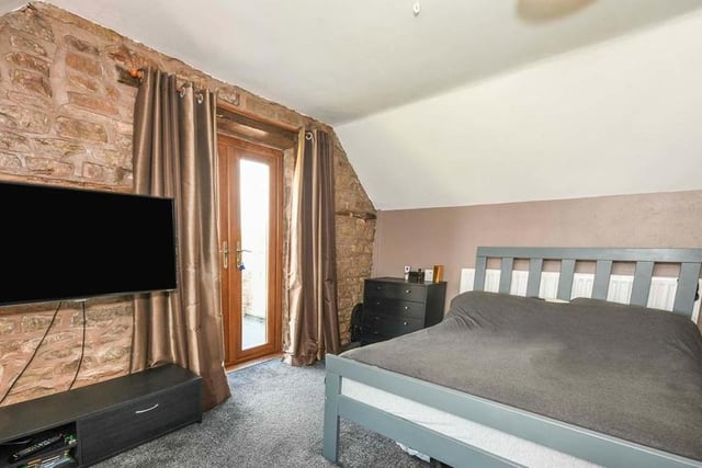 The impressive double bedroom is not only a generous size. It also boasts French doors leading on to a patio.