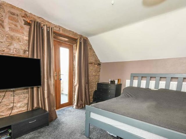 The impressive double bedroom is not only a generous size. It also boasts French doors leading on to a patio.