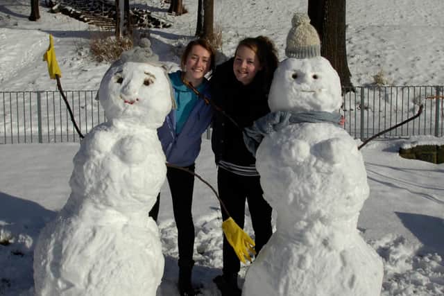 Students Jessica Brooks and Emily Glandenning with their snowwomen at Crookes Valley Park