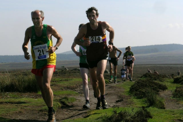 Kevin Lomas of Charnwood AC (left) and Tim O'Neal of Dark Peak Fell Runners leading a group along Stanage Edge in 2008