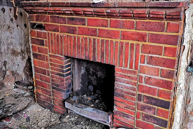 A brick fireplace remains inside.
