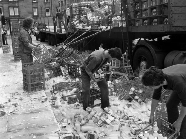 Men clearing up after a milk lorry shed its load of milk bottles and cartons in Semple Street, September 1981.