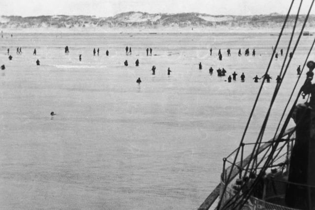 Allied troops wade out to evacuation vessels moored off Dunkirk during World War II, 1940. (Photo by Keystone/Hulton Archive/Getty Images)