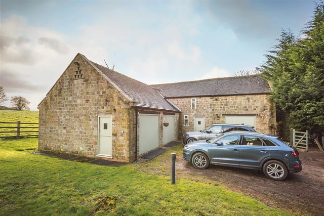 A detached stone outbuilding incorporates three garages and storage space and did have planning permission to be turned into further living accommodation.