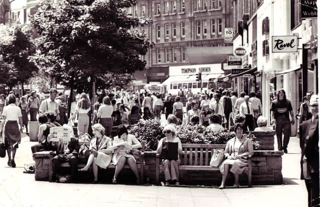 People relaxing in the sun on Fargate in Sheffield city centre in 1976