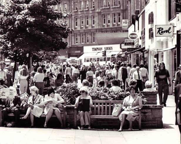 People relaxing in the sun on Fargate in Sheffield city centre in 1976
