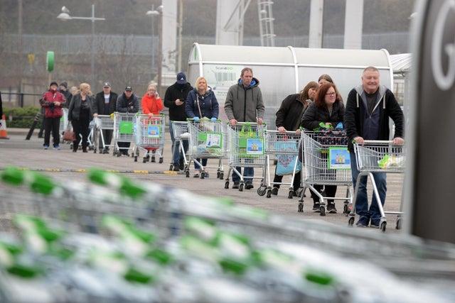 Shoppers at Asda in South Shields on the fourth day of lockdown. Queues to enter supermarkets and shops has become the new normal as people adjust to social distancing measures during the pandemic.