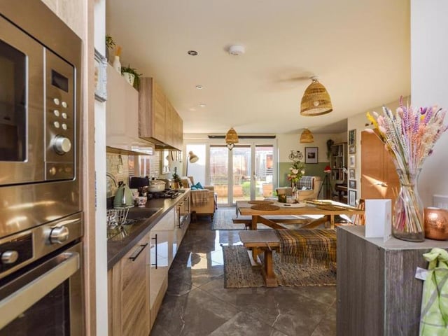 The open-plan kitchen and living area from a third angle. As you can see, there is room for a dining table and relaxing chairs. It really is the ideal space for entertaining guests or simply unwinding after a long day at work.
