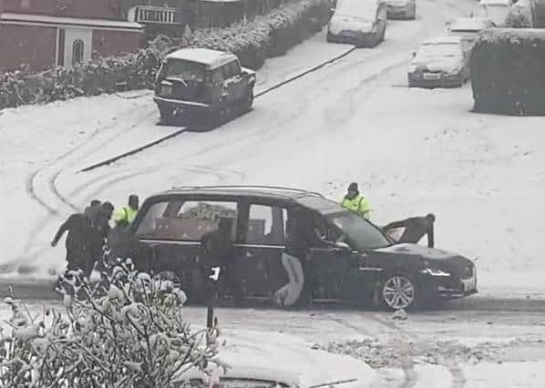 The East Herringthorpe residents were spotted rescuing the hearse in the snow in a video captured by resident Michelle Mulcahy.