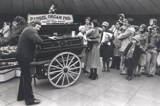 Barrel Organ Phil entertains passersby in Sheffield's famous Hole in the Road in April 1977