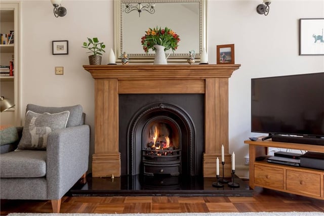 Original fireplace with working flame gas fire in living room.