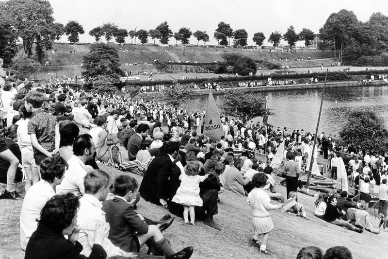 Our picture shows a few of the hundreds of people lining the grassy banks in the sunshine at Crookes Valley Park to watch the Water Sports Gala,  June 1970