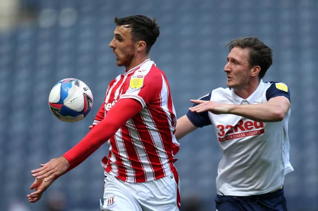 PRESTON, ENGLAND - SEPTEMBER 26: Lee Gregory of Stoke City battles for possession with Ben Davies of Preston North End during the Sky Bet Championship match between Preston North End and Stoke City at Deepdale on September 26, 2020 in Preston, England. Sporting stadiums around the UK remain under strict restrictions due to the Coronavirus Pandemic as Government social distancing laws prohibit fans inside venues resulting in games being played behind closed doors. (Photo by Lewis Storey/Getty Images)