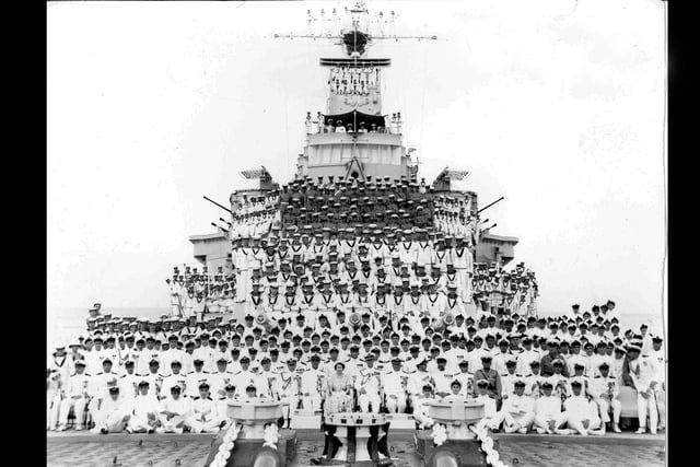 The men of HMS Sheffield in 1953 posing with Her Majesty the Queen.
