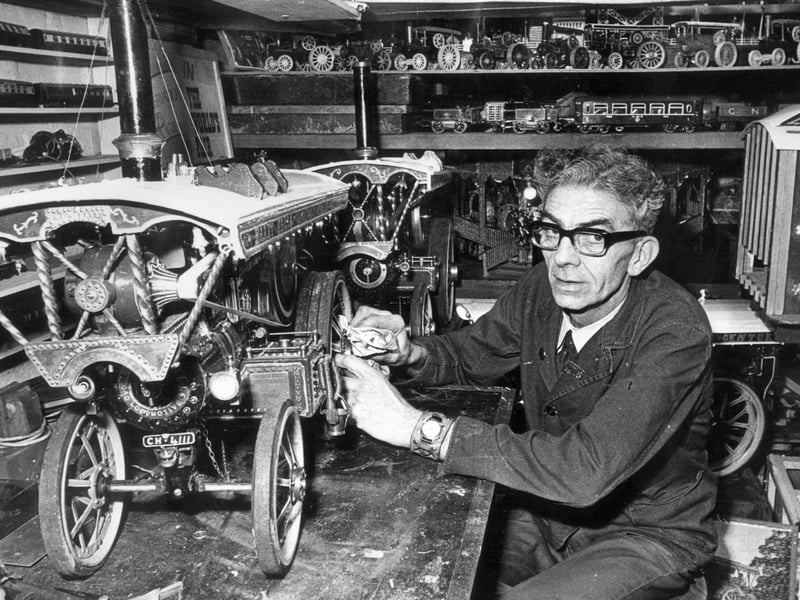 Albert Cooling, head caretaker at Westfield school, Mosborough, pictured with one of his models of a steam engine he has made, April 10, 1975