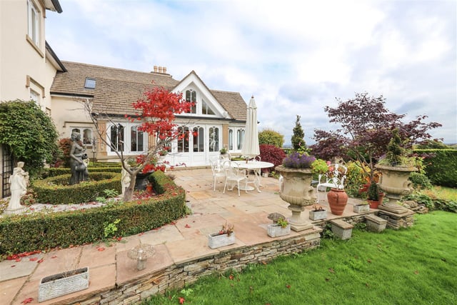 The house sits in a "simply stunning" two acre, gated plot with manicured gardens surrounding the property.