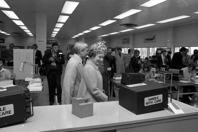 Queen Elizabeth II visits the Ferranti electronics factory at Silverknowes Edinburgh in July 1980. The Queen smiles at the Handle With Care sign on the box.