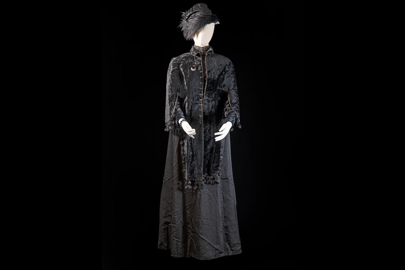This outfit represents death as well as  the diaspora. The original owner was sent the costume by her son in the United States, who had emigrated in the late 1800s but who regularly sent parcels of clothes home to his mother.