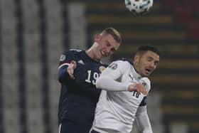 Scotland's Oliver McBurnie, left, jumps for a header with Serbia's Dusan Tadic during the Euro 2020 playoff final soccer match between Serbia and Scotland, at the Rajko Mitic stadium in Belgrade, Serbia, Thursday, Nov. 12, 2020. (AP Photo/Darko Vojinovic)