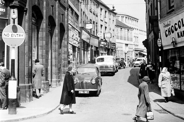 Change Alley, Sheffield, which ran from High Street to Norfolk Street, with Thomas A Ashton Limited, Engineers, on the left, and Thornton's Chocolate Kabin on the right, May 3, 1960