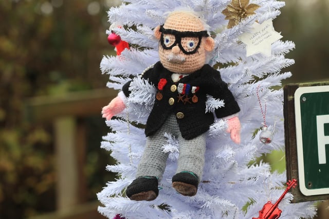 A hand knitted Christmas bauble of Captain Sir Tom Moore hangs on the village Christmas tree in the centre of Allington, Lincolnshire.