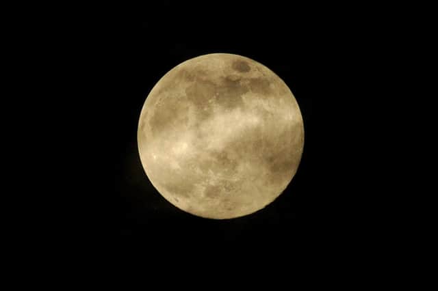 Last night's supermoon appears almost gold in this beautiful shot.