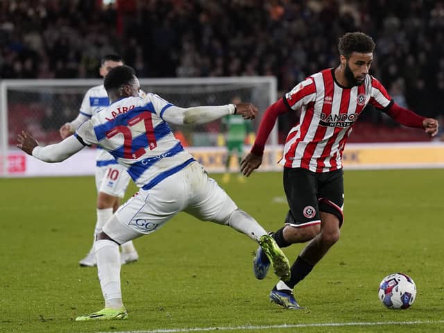 Jayden Bogle of Sheffield United skips past Ethan Laird of QPR on his return from injury: Andrew Yates / Sportimage