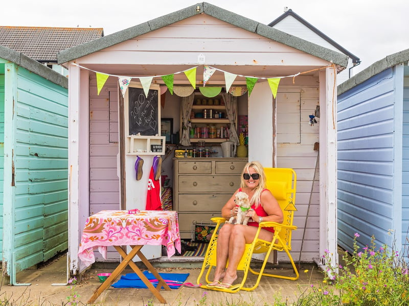 Beach hut lover Jan Norman and dog Billy make the most of the return to summer temperatures. Picture: Mike Cooter (150721)
