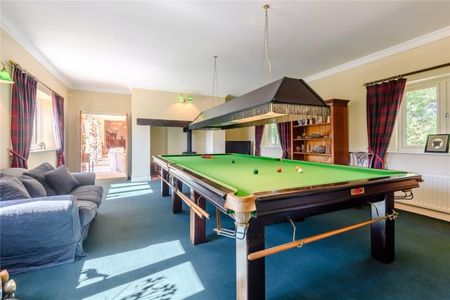 There are four reception rooms throughout the property, with this space currently used as a games room. It features a large inglenook fireplace and adjoining the office and integra triple garage. These rooms were designed with an annex in mind, but planning would be required.