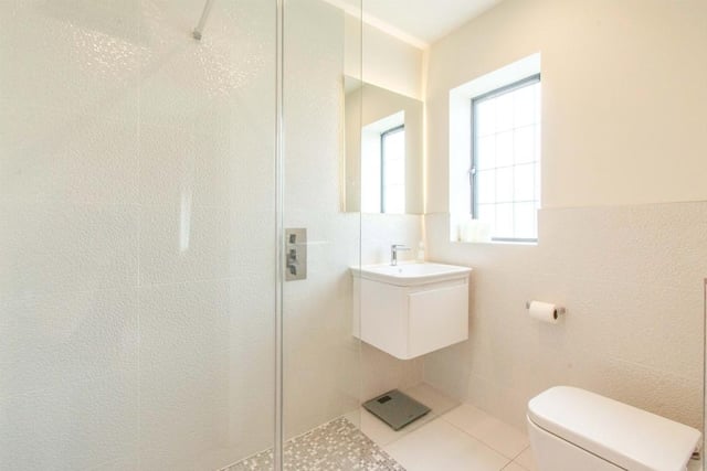 Ensuite Shower Room - Fitted with a WC, a wash hand basin fitted into a vanity unit and a double shower cubicle with shower. There is a rear facing frosted double glazed window and tiling to the walls and floor.