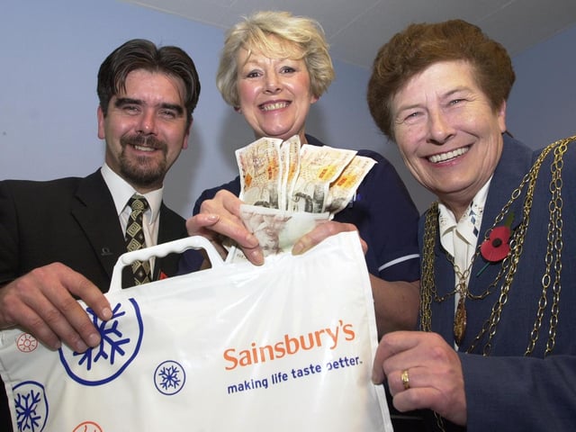 The Mayor of Doncaster, Councillor Maureen Edgar, and Carol Spiller, Cancer Detection Board member, accept £450 from Stephen Ronan, Doncaster Sainsbury's duty manager, on behalf of the St John's Hospice, Balby. The presentation took place at the Frenchgate store in 2000