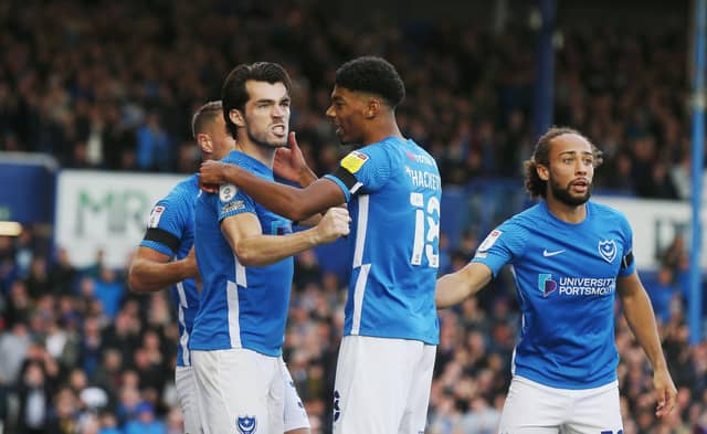 John Marquis gets the plaudits from his Pompey team-mates following his 51st-minute goal. Picture: Joe Pepler