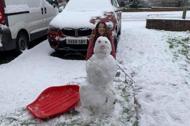 Talia Bryant with a snowman in Petersfield. Picture: Angela Le Santo