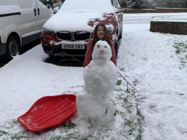 Talia Bryant with a snowman in Petersfield. Picture: Angela Le Santo