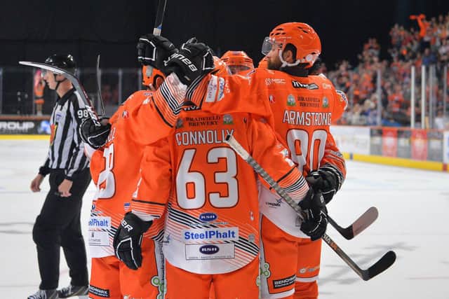 John Armstrong congratulated after equalising against Guildford on Saturday night. Pic Dean Woolley