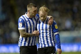 Barry Bannan and Jack Hunt share a moment during Sheffield Wednesday's win over Wigan Athletic.