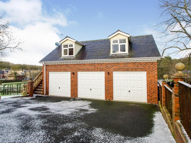 Three electric, up-and-over doors, wall mounted combination boiler, power and light, with a self-contained annexe above.