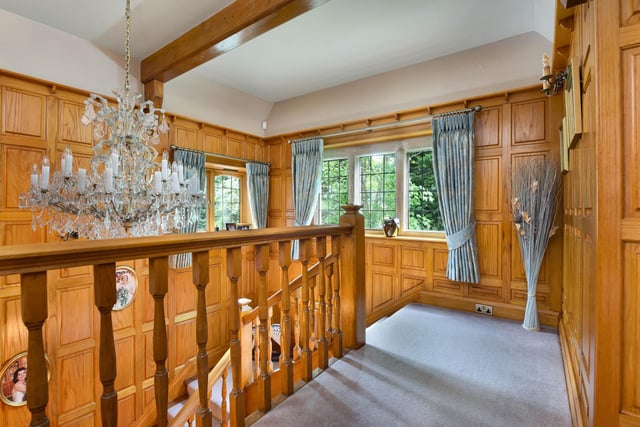 The landing carries on the wood panelling from the ground floor.