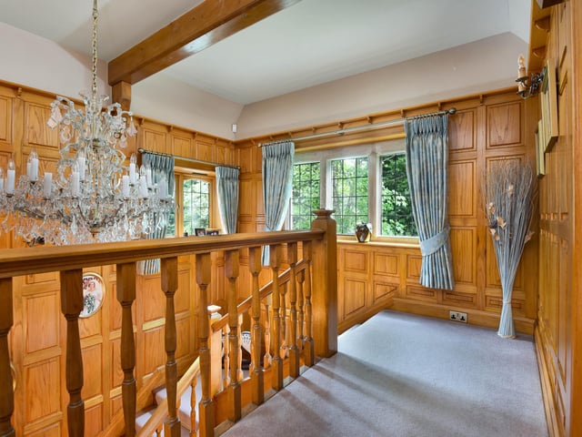 The landing carries on the wood panelling from the ground floor.