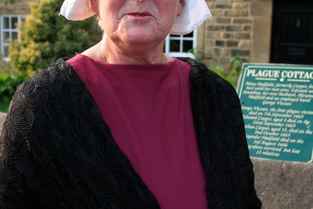 Joan Plant direct descendant of two plague survivors outside the plague cottage where the outbreak began, pictured ahead of a Plague play back in 2009