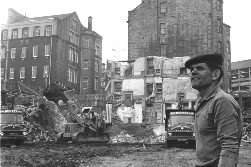 A bulldozer piles up waste as the demolition of St James Square in Edinburgh continues in August 1966.
