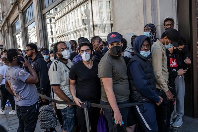 Shoppers were seen standing close together as they waited for the Nike Town store to open.
