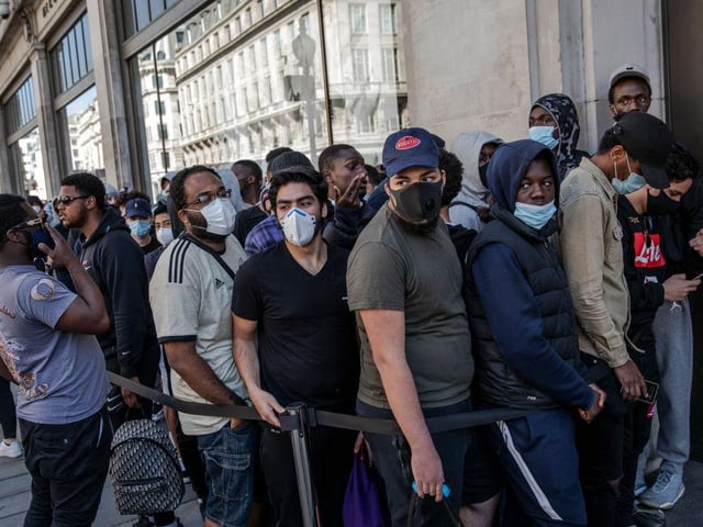 Shoppers were seen standing close together as they waited for the Nike Town store to open.