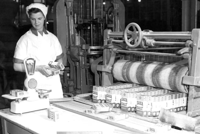 A worker checking the weights of boxes of Saxa Salt at Cerebos. Photo: Hartlepool Museum Service.