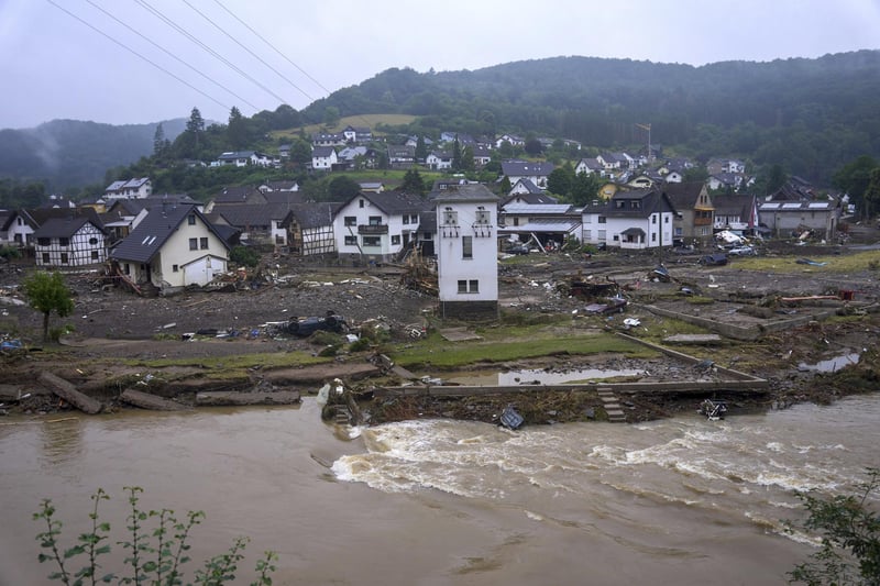 The river Ahr passes the village of Schuld, Germany, Friday, July 16, 2021 the day after the flood disaster. Heavy rains caused mudslides and flooding in the western part of Germany. Multiple have died and dozens are missing as severe flooding in Germany and Belgium turned streams and streets into raging, debris-filled torrents that swept away cars and toppled houses. (Thomas Frey/dpa via AP)